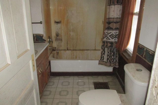 full bath featuring tile patterned floors, toilet, and shower / bathtub combination