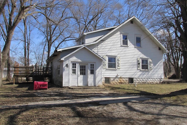 back of property with a wooden deck