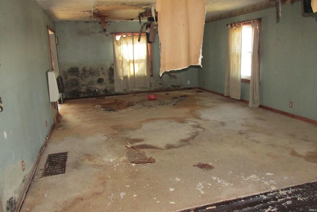 spare room featuring visible vents, plenty of natural light, and radiator heating unit