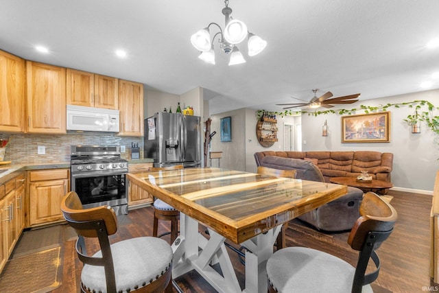 kitchen with dark wood-style flooring, light brown cabinetry, stainless steel appliances, light countertops, and tasteful backsplash