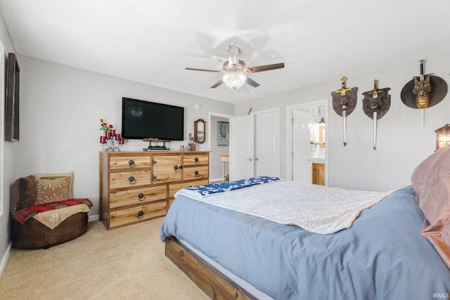 bedroom with connected bathroom, baseboards, light colored carpet, and ceiling fan