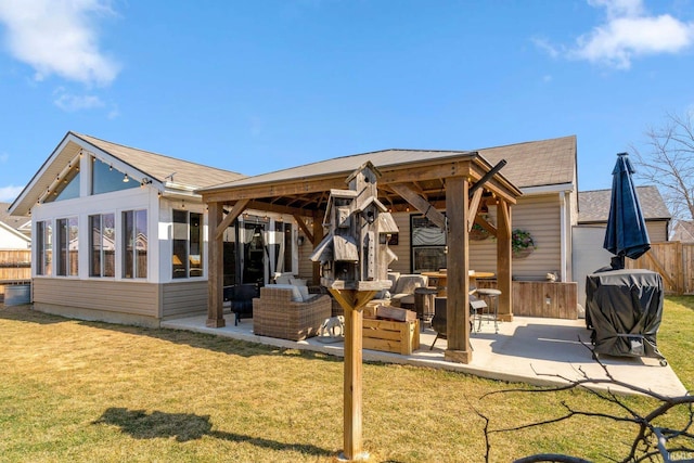 back of property featuring a lawn, a patio, and fence