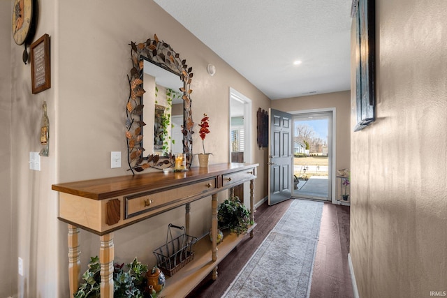 hall with dark wood-style floors and baseboards