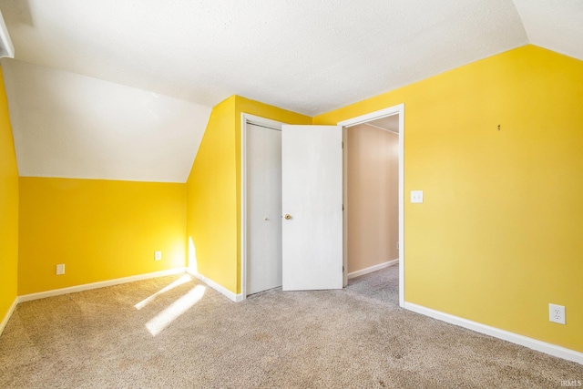 bonus room featuring vaulted ceiling, baseboards, and carpet floors