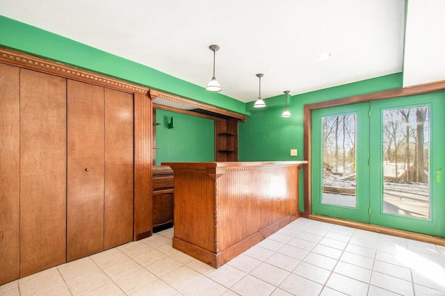 kitchen featuring decorative light fixtures and light tile patterned floors