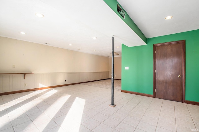 interior space featuring light tile patterned floors, recessed lighting, wainscoting, and baseboards