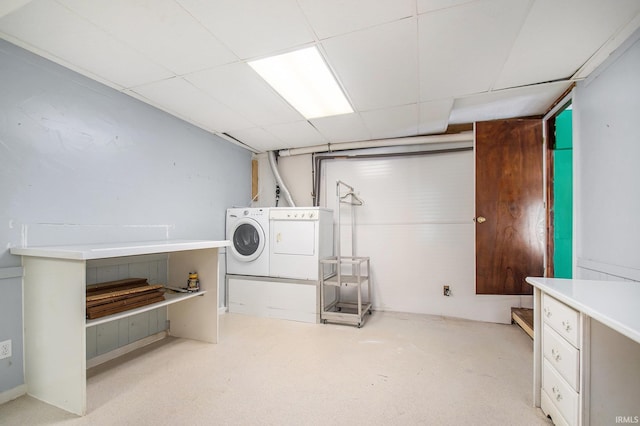 finished basement with separate washer and dryer and a paneled ceiling