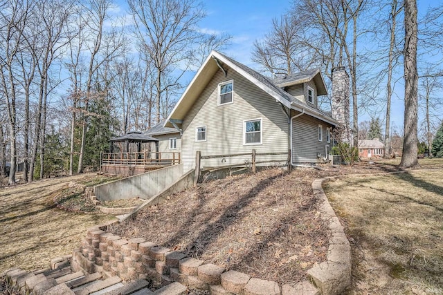 exterior space with a gazebo and a chimney