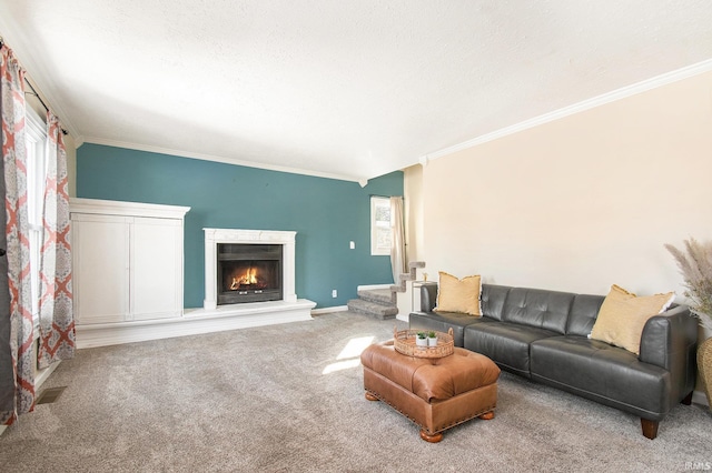 carpeted living area featuring visible vents, baseboards, stairs, ornamental molding, and a warm lit fireplace