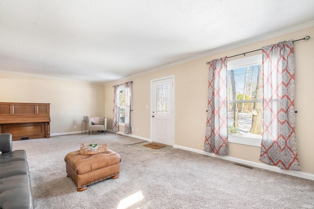 living room with a wealth of natural light, visible vents, and baseboards