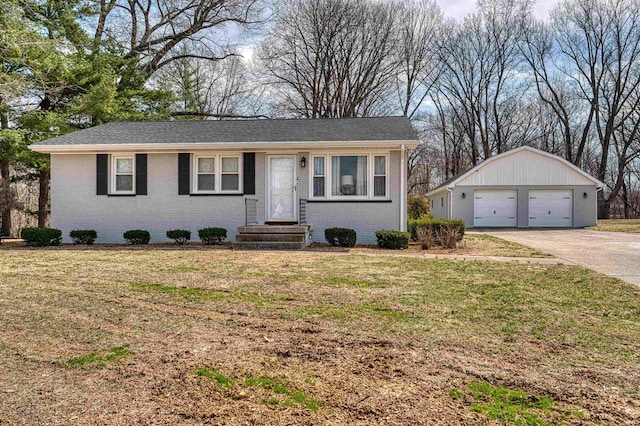 single story home with a garage, a front yard, an outbuilding, and brick siding