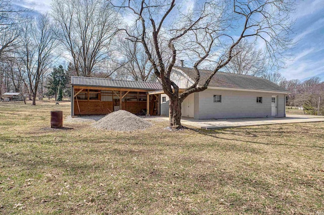 exterior space with a front lawn and a patio