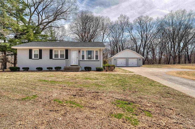 ranch-style house with an outbuilding, a front lawn, a garage, and brick siding