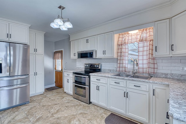 kitchen featuring a sink, backsplash, stainless steel appliances, white cabinets, and hanging light fixtures