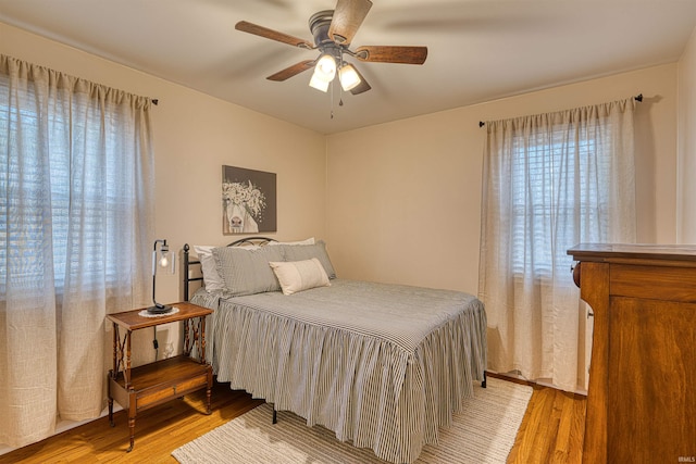 bedroom featuring light wood-style flooring and a ceiling fan