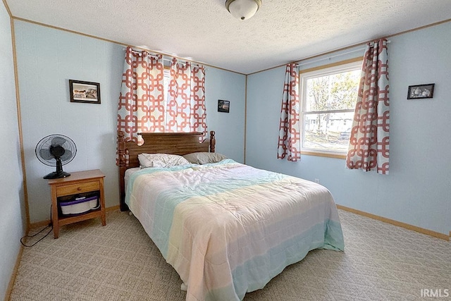 bedroom with baseboards, carpet floors, and a textured ceiling