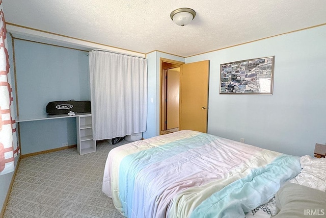 bedroom with carpet flooring and a textured ceiling