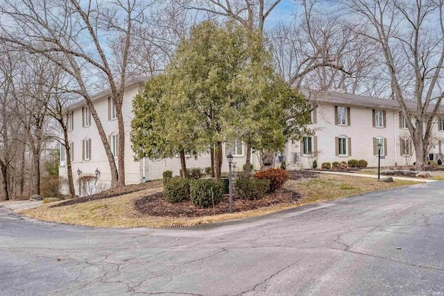 colonial home featuring brick siding