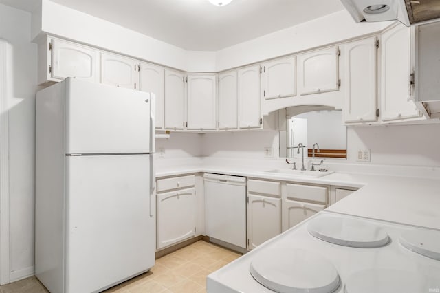 kitchen with white appliances, light countertops, and a sink