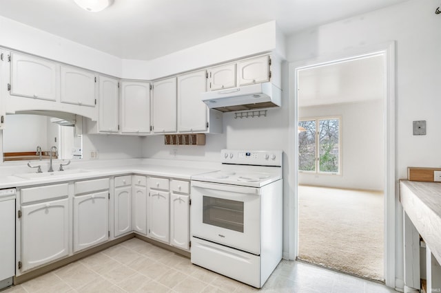 kitchen with under cabinet range hood, light colored carpet, light countertops, white appliances, and a sink