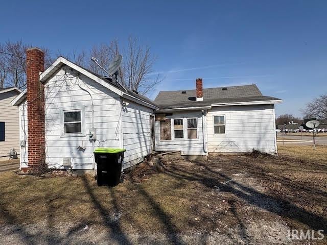 back of property featuring a chimney