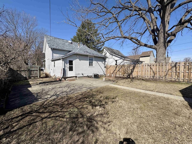 back of house featuring a fenced backyard and a patio area