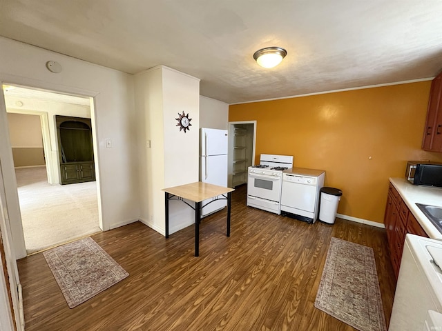 kitchen with brown cabinets, wood finished floors, white appliances, light countertops, and baseboards