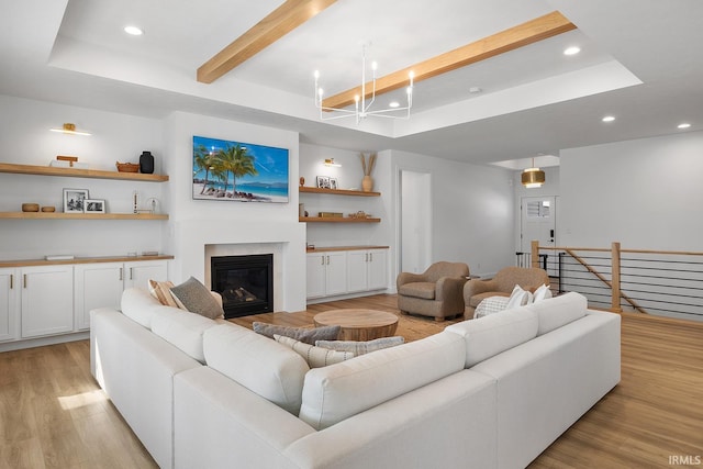 living room with beam ceiling, a glass covered fireplace, recessed lighting, and light wood-type flooring