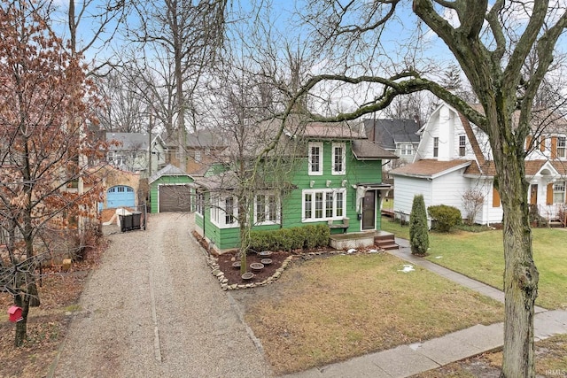 view of front of house featuring dirt driveway, a gambrel roof, a front yard, a garage, and an outbuilding