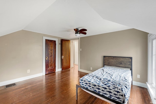 bedroom with visible vents, ceiling fan, baseboards, vaulted ceiling, and hardwood / wood-style floors