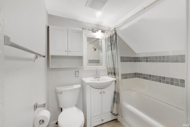 bathroom with visible vents, toilet, shower / tub combo with curtain, vanity, and vaulted ceiling