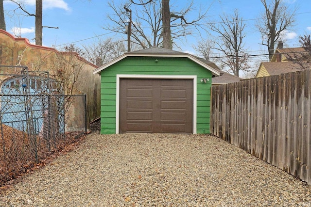 detached garage featuring fence