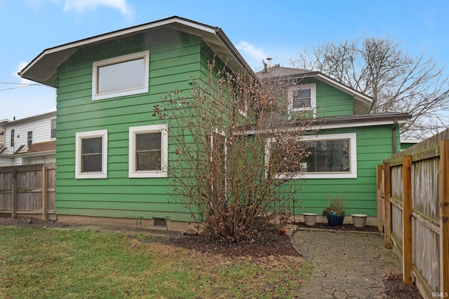 rear view of house with a fenced backyard