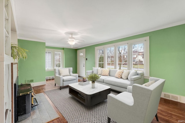 living room featuring crown molding and wood finished floors