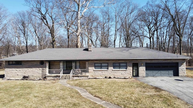 ranch-style home with aphalt driveway, stone siding, covered porch, and a front yard