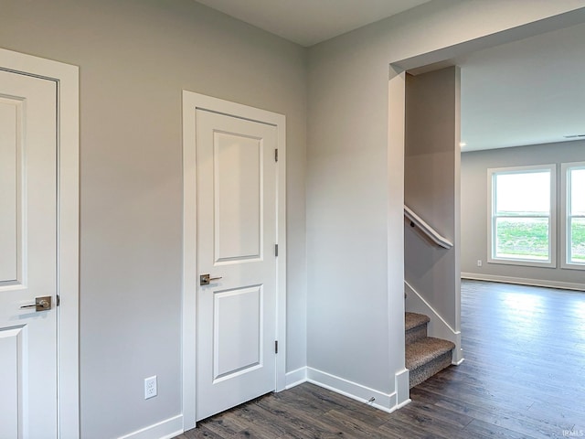 stairway featuring baseboards and wood finished floors