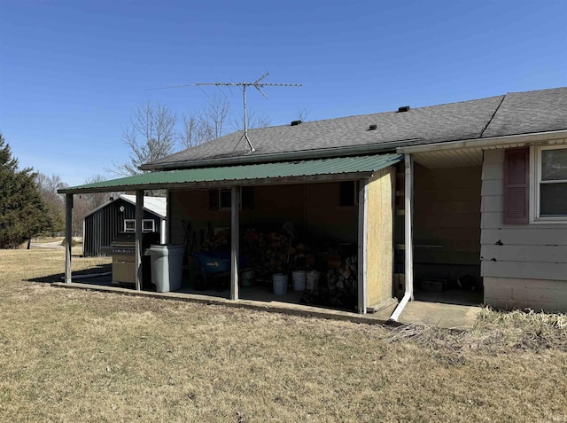 exterior space with a yard and a shingled roof