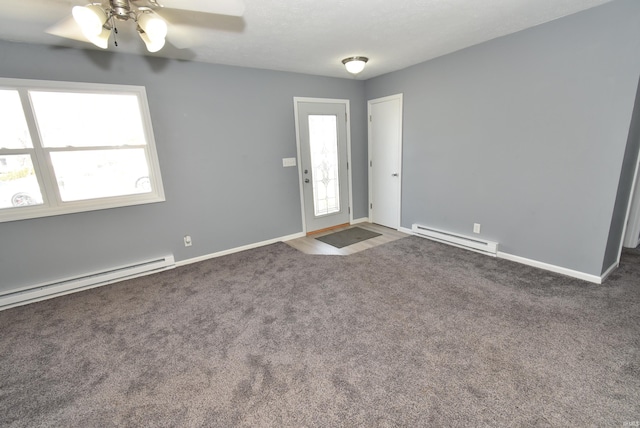 interior space with ceiling fan, baseboards, baseboard heating, and carpet floors