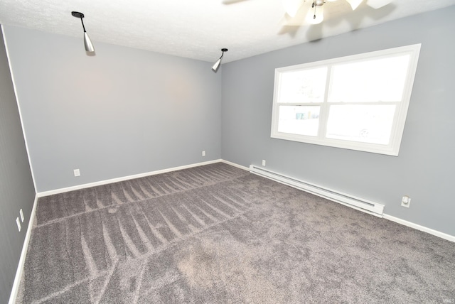 spare room with a textured ceiling, baseboards, carpet floors, and a baseboard radiator