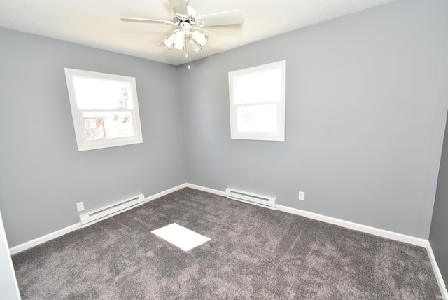 carpeted empty room with a baseboard heating unit, plenty of natural light, and baseboards