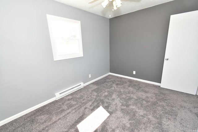 carpeted empty room with a baseboard heating unit, a ceiling fan, and baseboards