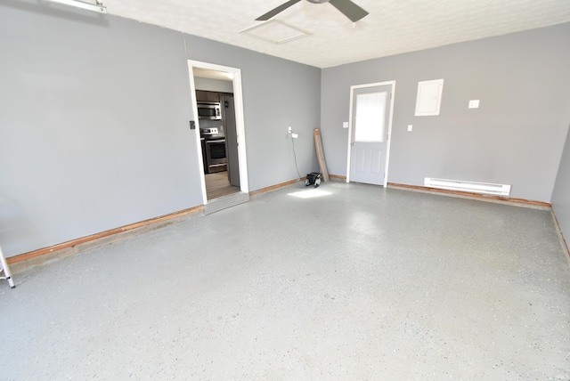 garage with baseboards, baseboard heating, and a ceiling fan