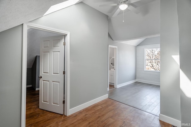 bonus room featuring ceiling fan, baseboards, lofted ceiling, and wood finished floors