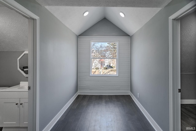 interior space with dark wood-style floors, baseboards, and a textured ceiling