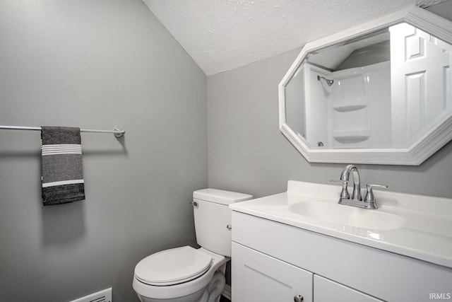 bathroom featuring toilet, vanity, vaulted ceiling, a textured ceiling, and a shower