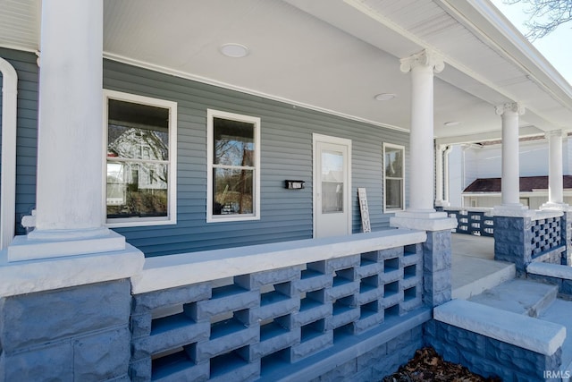 view of exterior entry with a porch