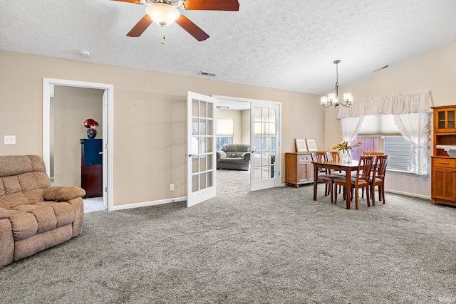 dining room featuring visible vents, a textured ceiling, french doors, carpet flooring, and vaulted ceiling