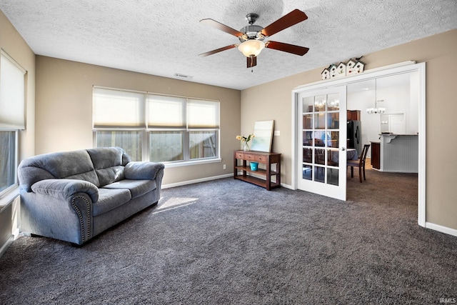 carpeted living room with visible vents, baseboards, ceiling fan with notable chandelier, french doors, and a textured ceiling