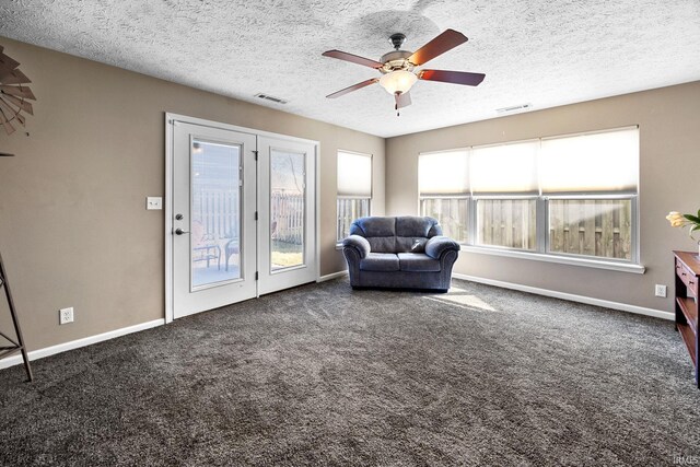 unfurnished room with visible vents, baseboards, carpet, and a ceiling fan