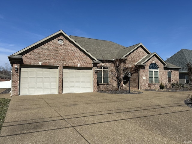 view of front of property with driveway, brick siding, an attached garage, and a shingled roof